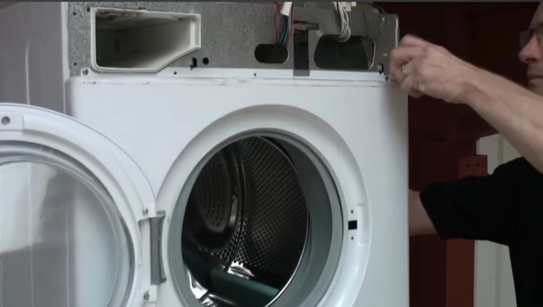 Washer repair technician testing a washing machine control board
